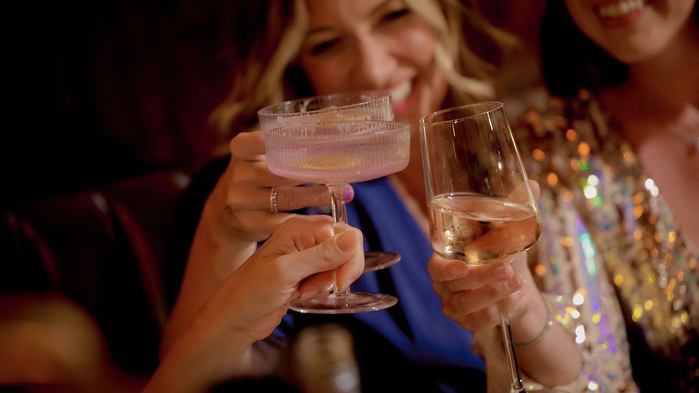 People toasting with champagne glasses at a celebration.