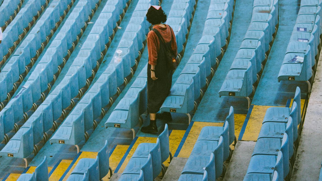 a person with a suitcase in a stadium