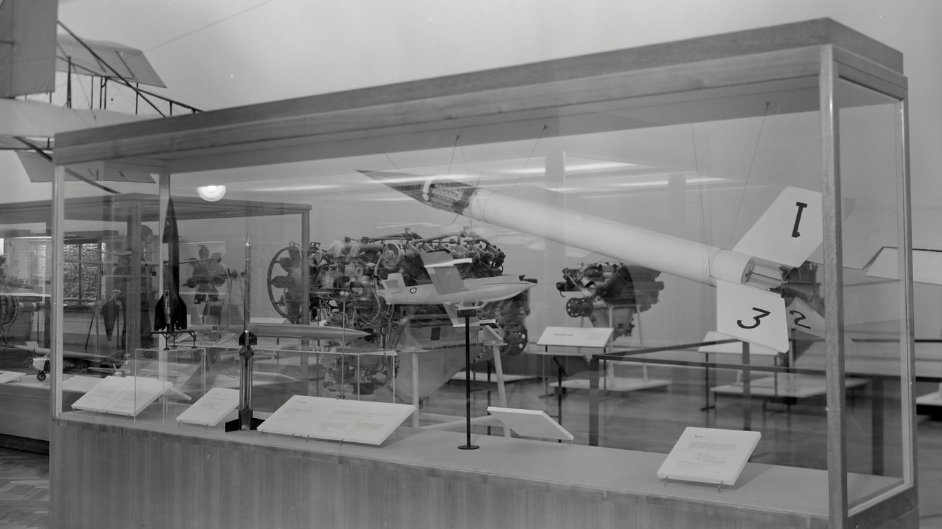 clear glass case with and engine and a rocket inside it