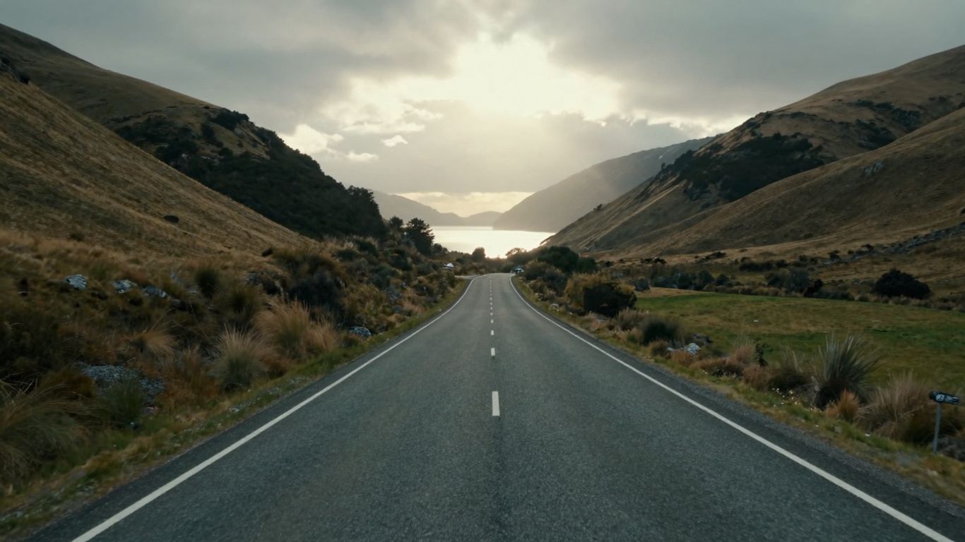 New Zealand landscape with a road towards a brighter horizon.