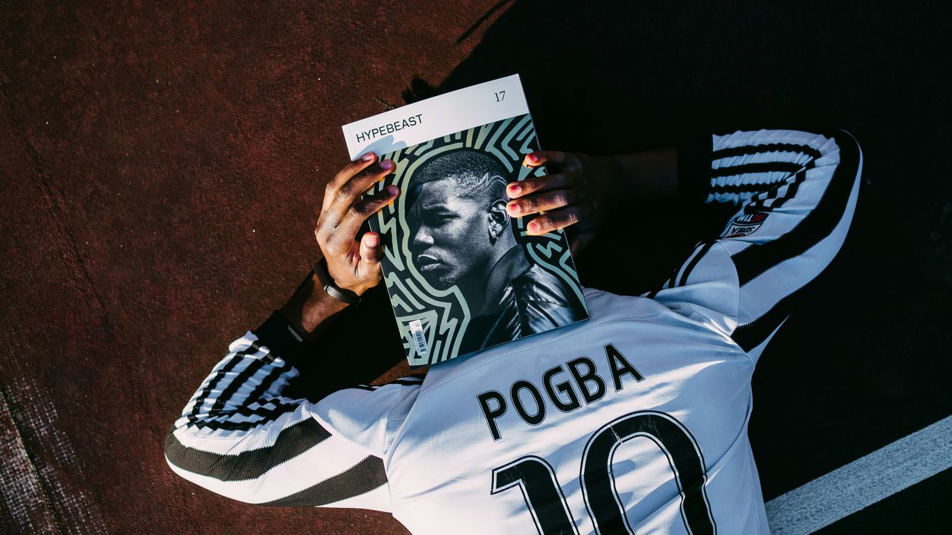 man in white and black adidas jersey shirt holding black and white textile