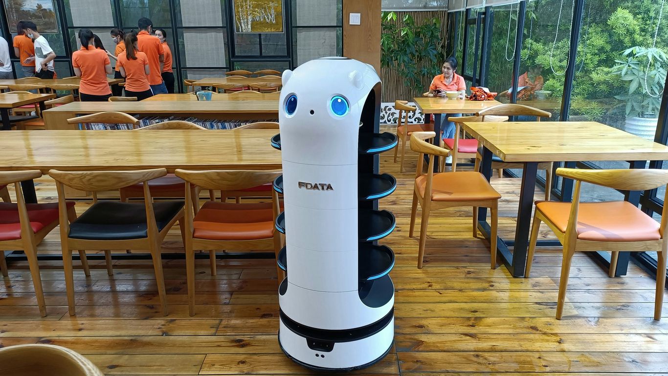 white and black plastic pitcher on brown wooden table
