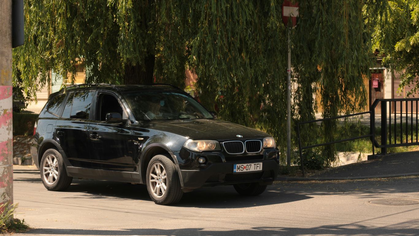 a black car parked on the side of the road