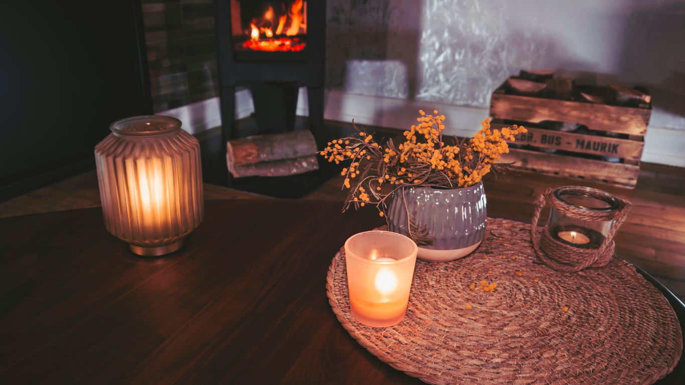 Candle and fall florals on a wooden table