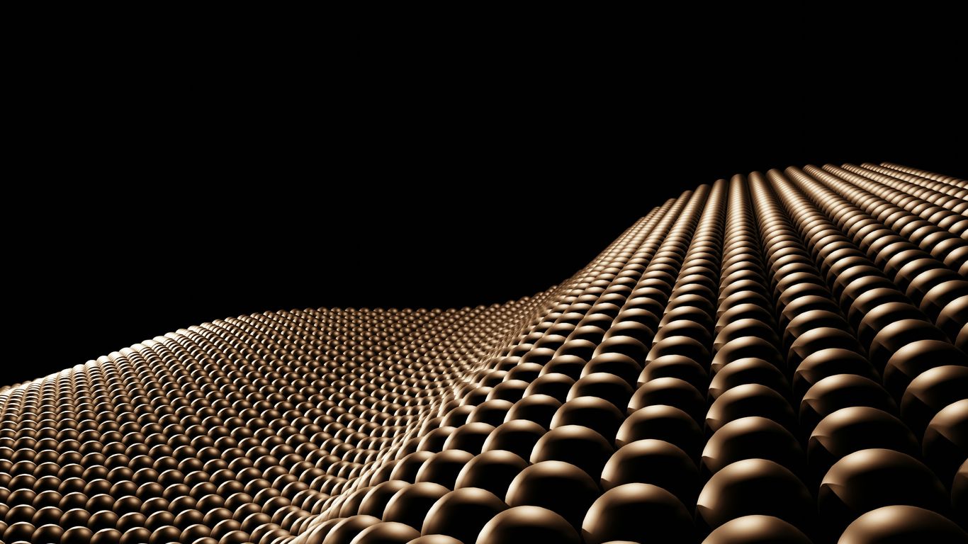 Bronze spheres forming a wavy surface against black