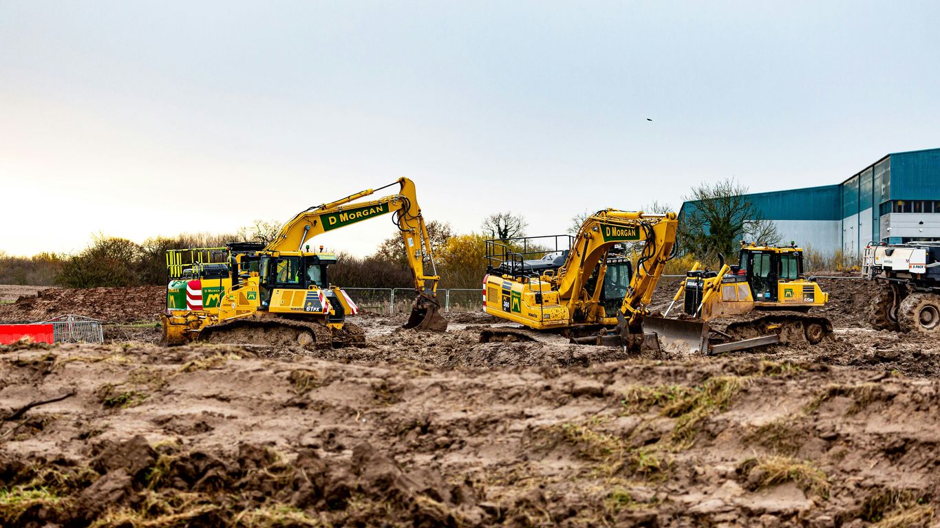 a group of construction equipment sitting in the dirt
