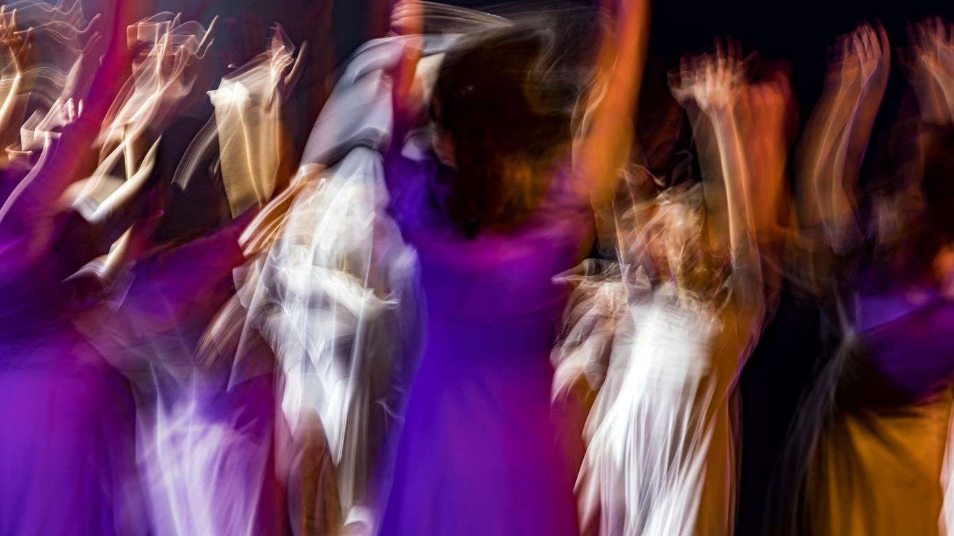 a blurry photo of a group of people dancing