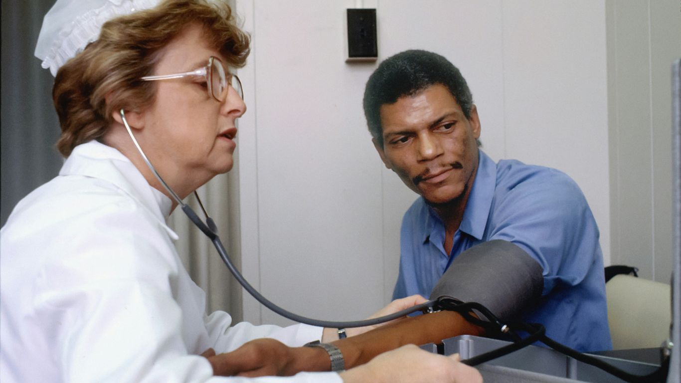 a doctor listening to a patient with a stethoscope