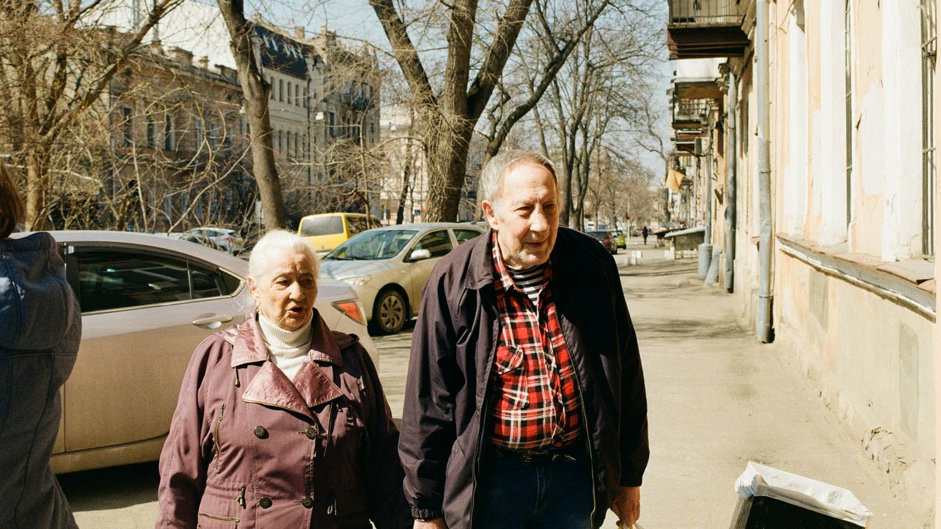 a group of people standing on a sidewalk