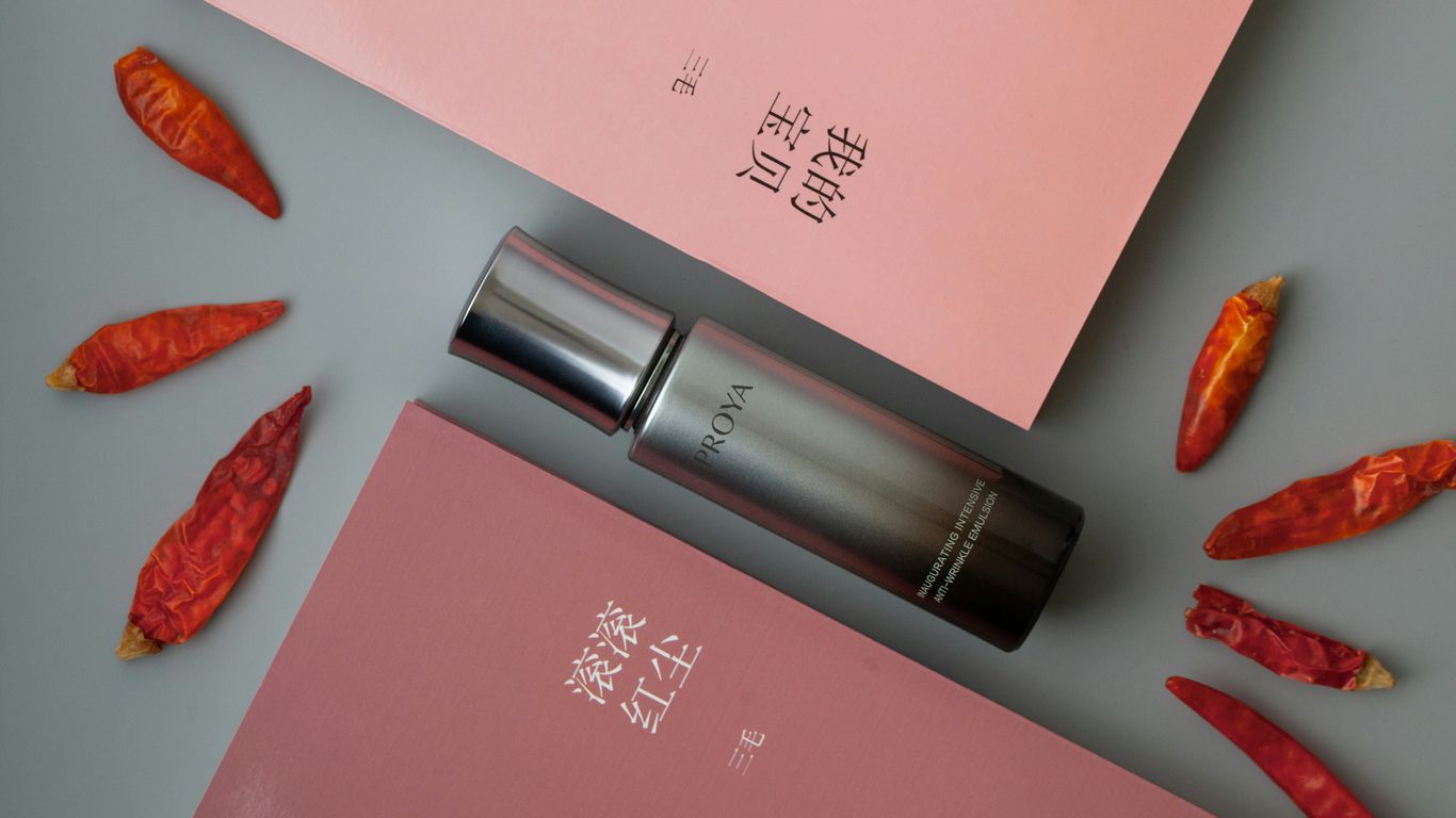 A pink box with a lipstick on top of it