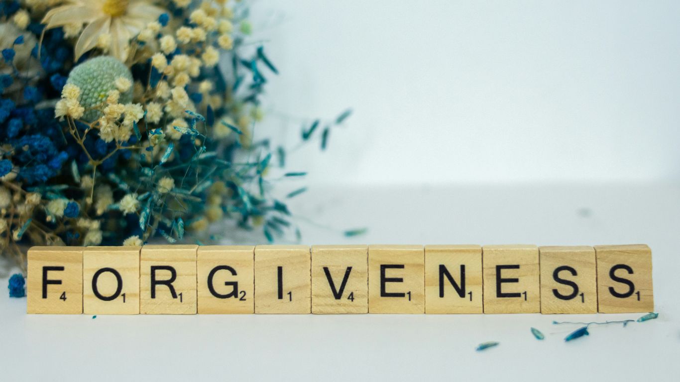 a scrabble type block spelling out the word forgiveness