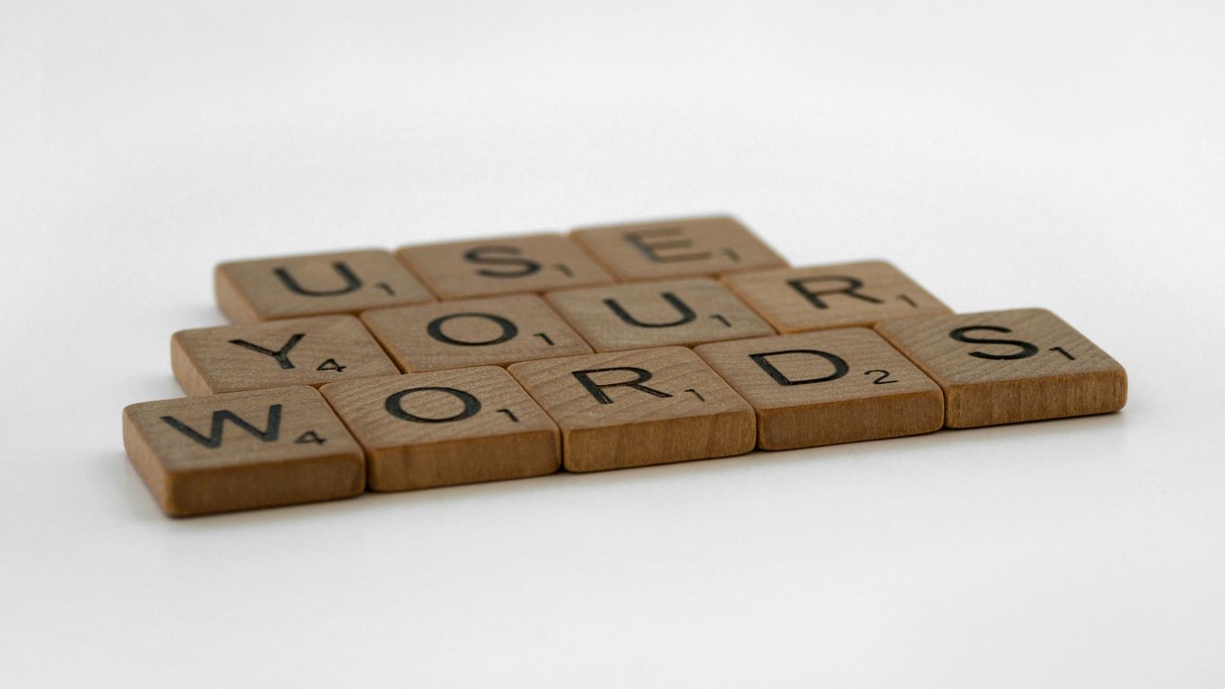 a scrabbled wooden block that says use your words