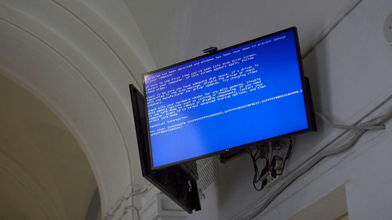 The TV displays a blue screen of death.