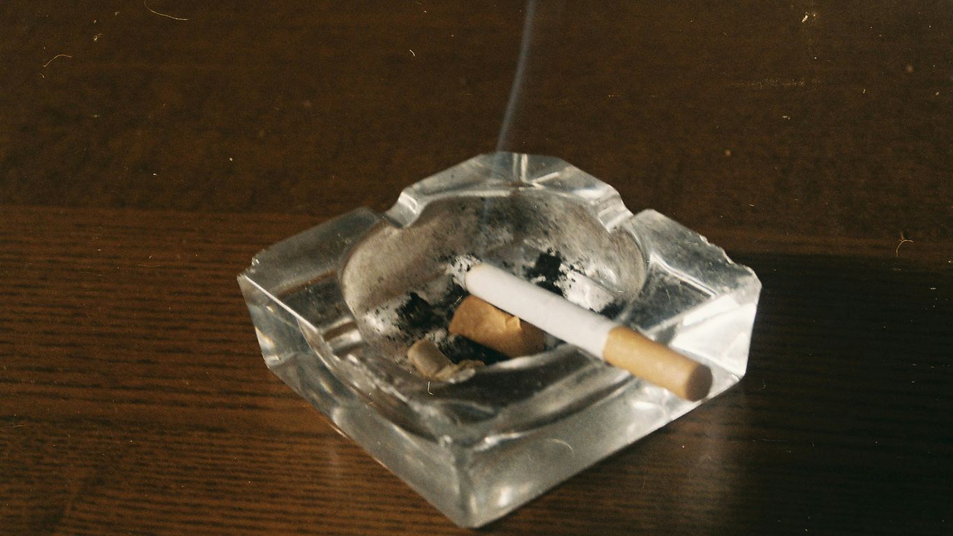 cigarette stick on clear glass ashtray
