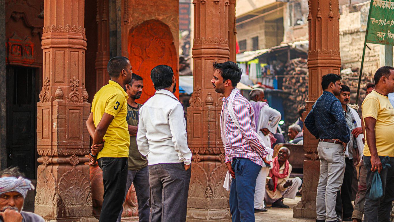 a group of people standing around a building