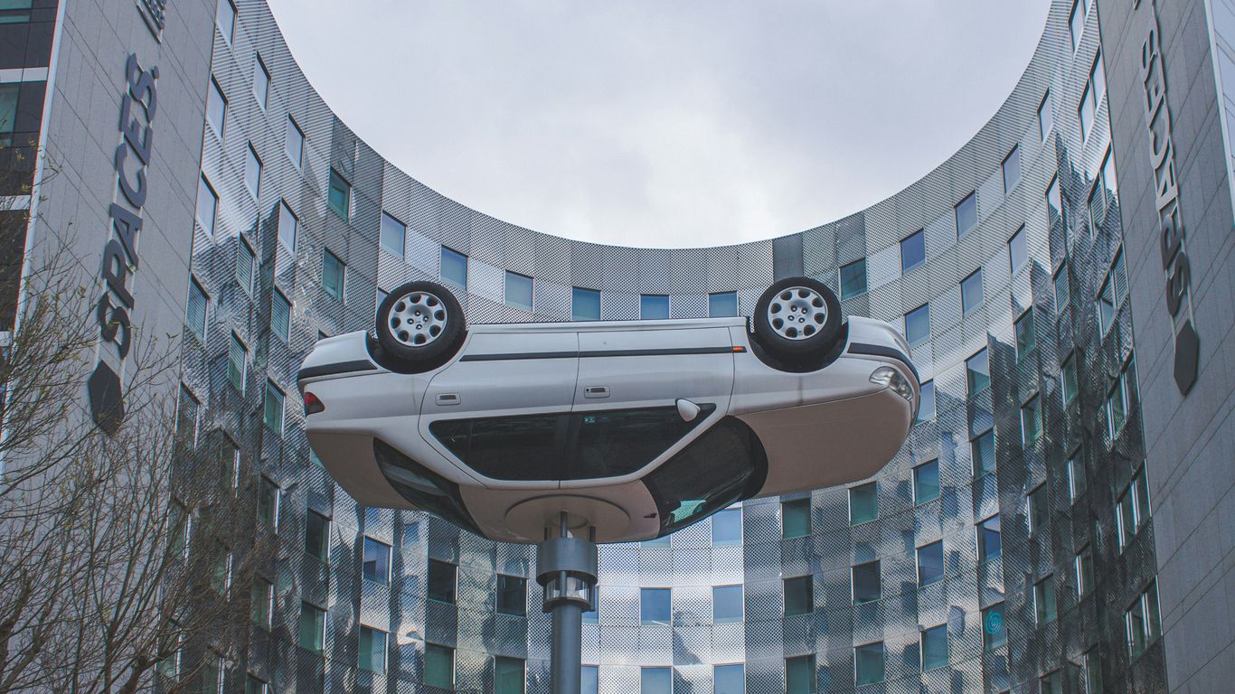a futuristic car is in front of a building