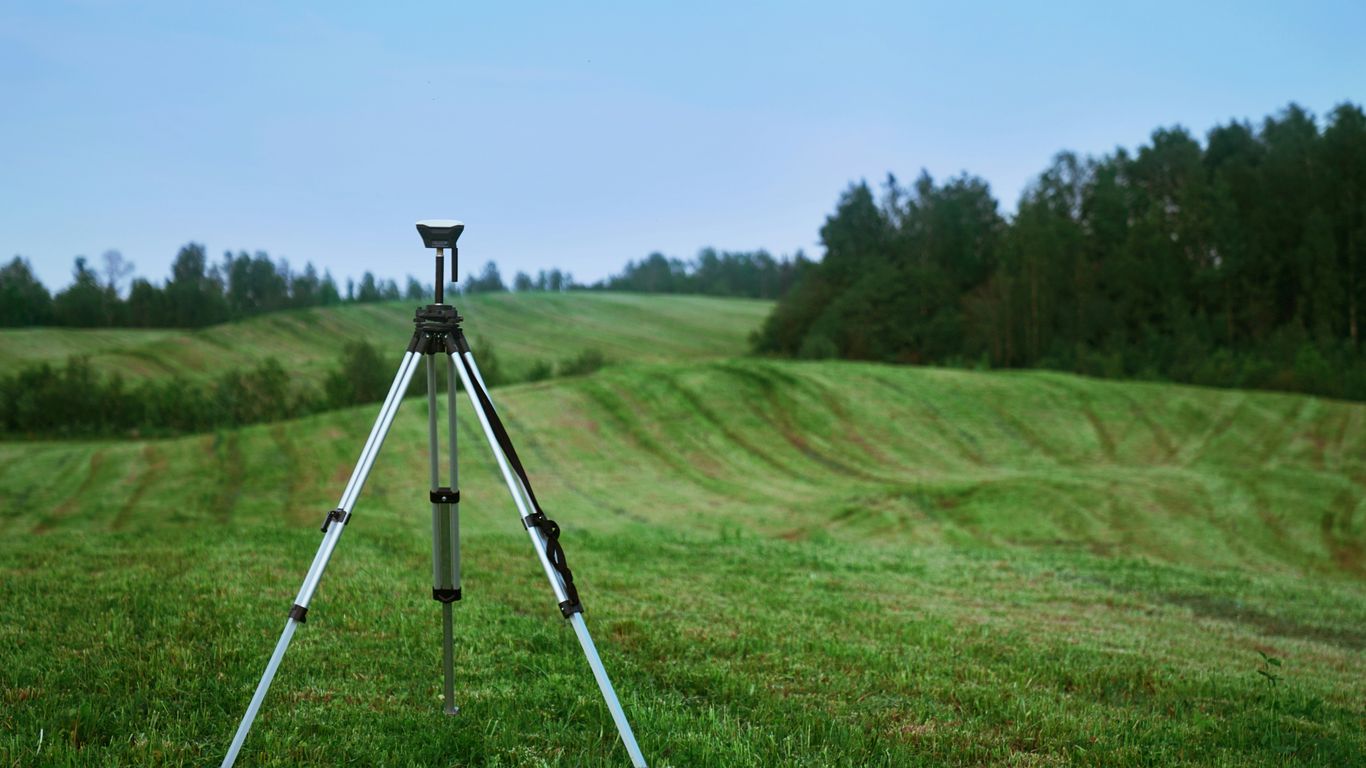 black and white tripod on green grass field during daytime