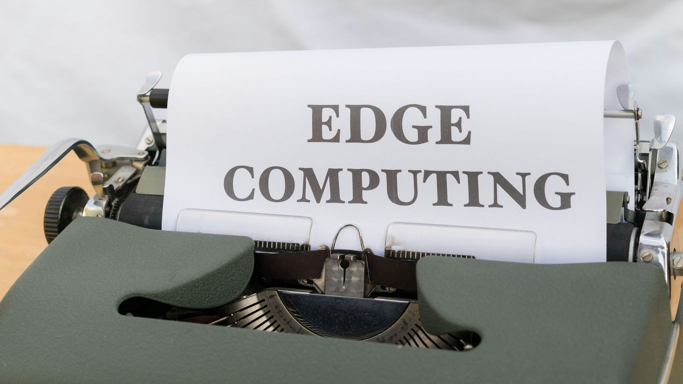 a close up of a typewriter with a paper that reads edge computing