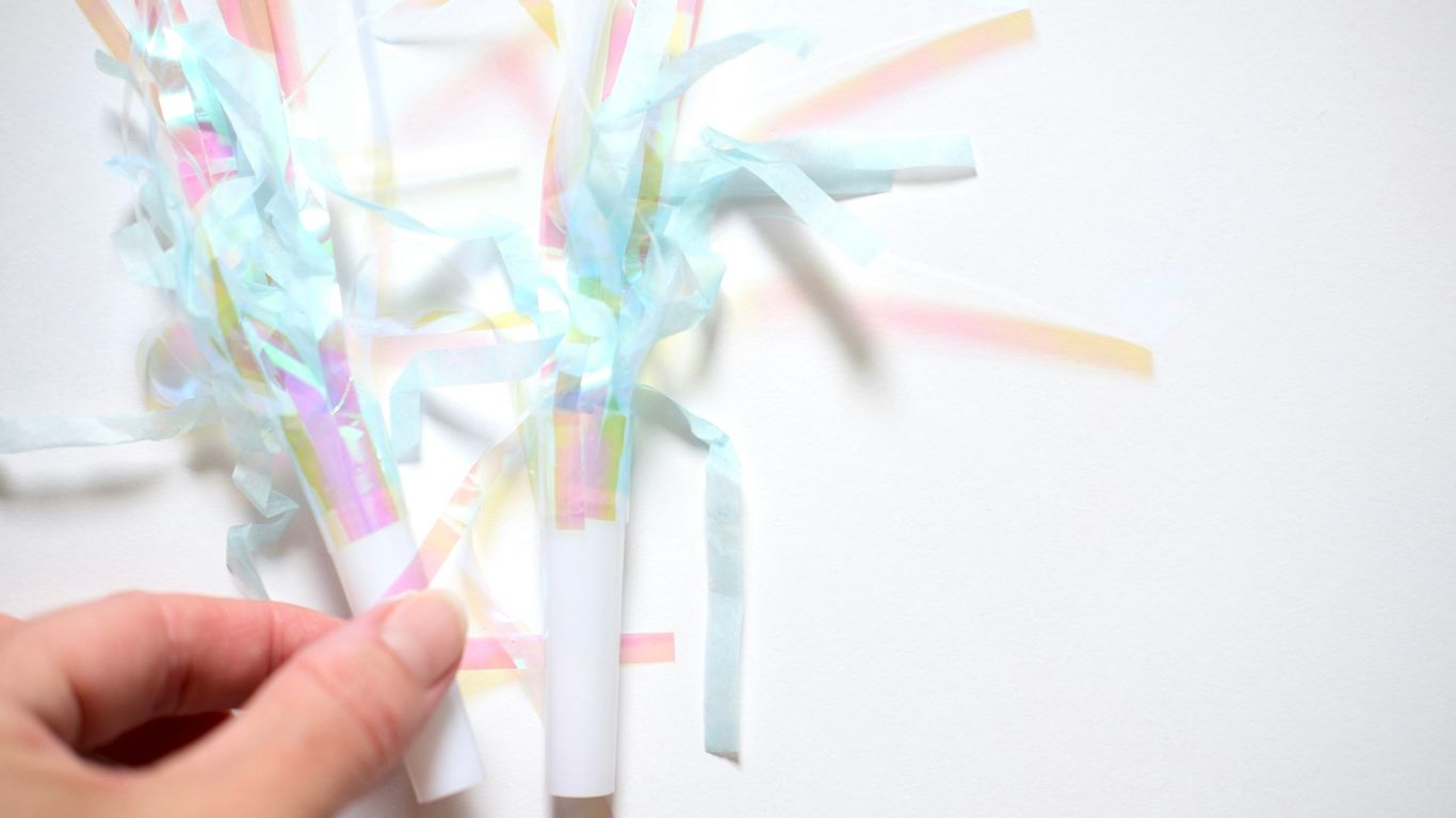 Pastel streamers on white background with hand
