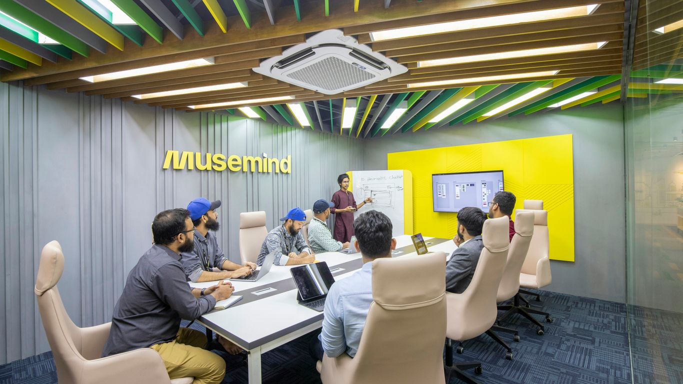 a group of people sitting around a conference table