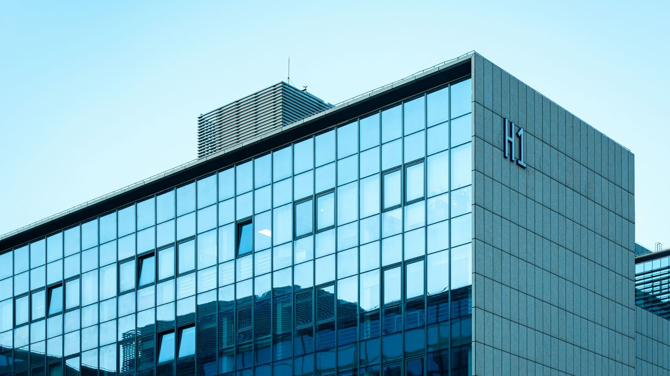 Modern glass building reflecting the clear sky