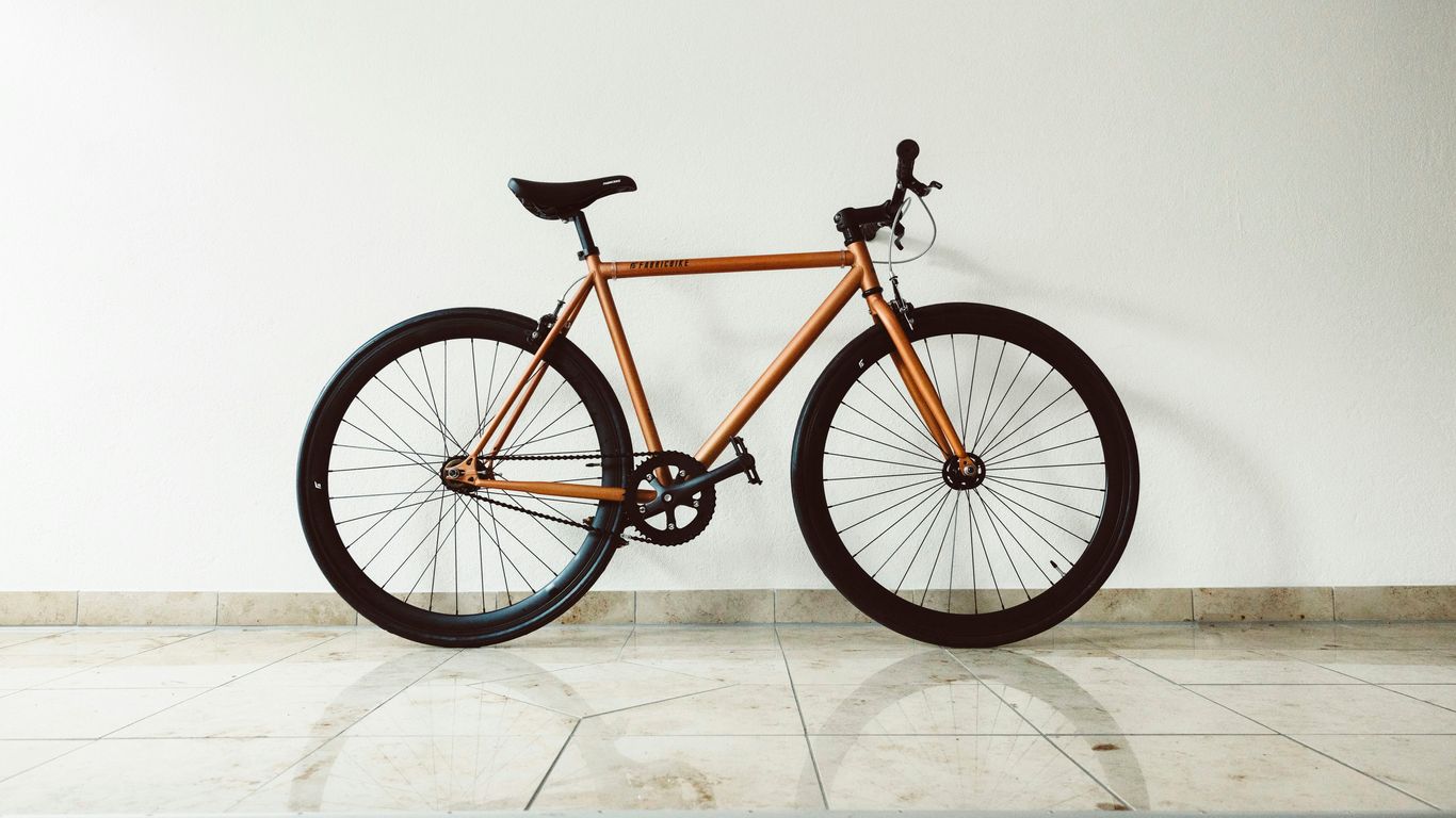 a bicycle leaning against a wall
