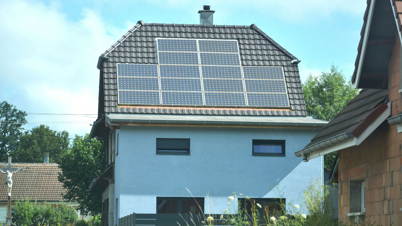 A house with a solar panel on the roof