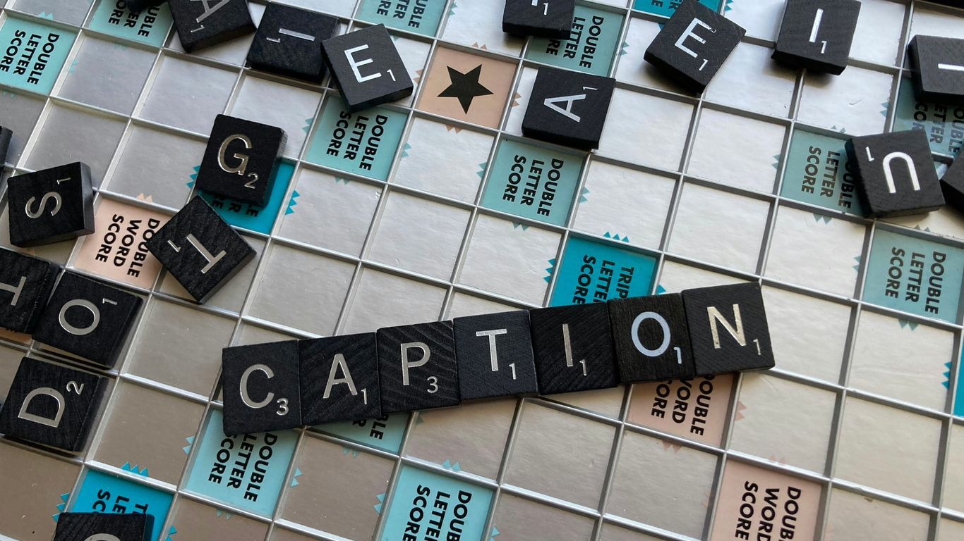 a close up of a scrabble tile wall with words written on it