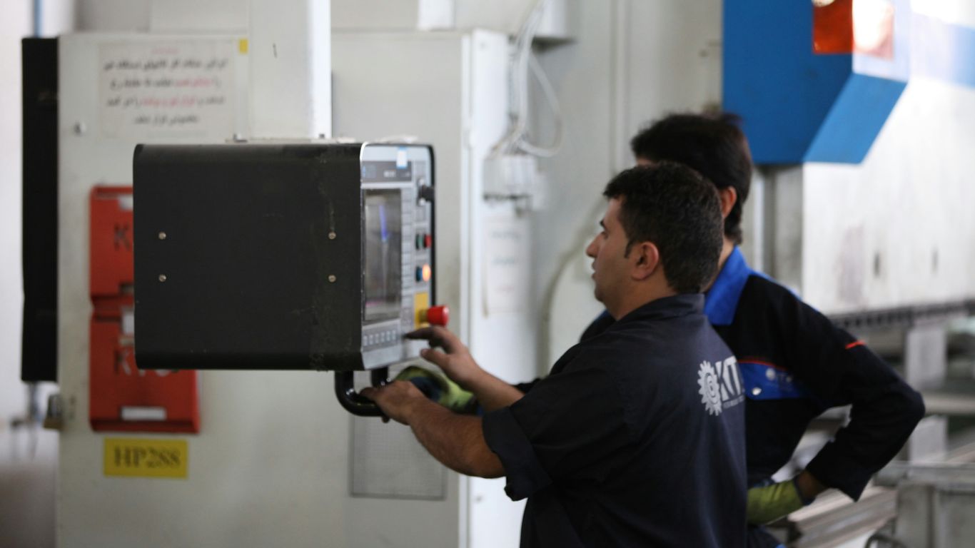 man in black shirt holding black smartphone