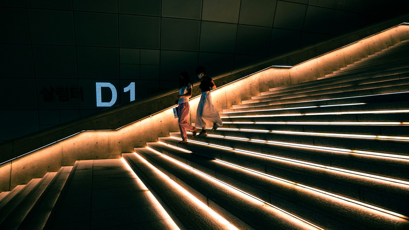 a couple of people that are walking down a set of stairs