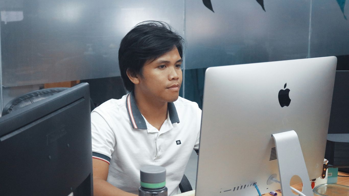 man in front of iMac