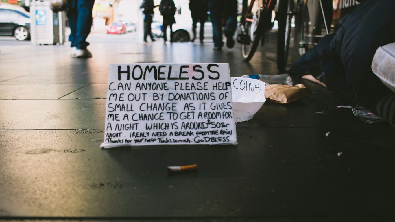 people walking on pathway and banner on ground