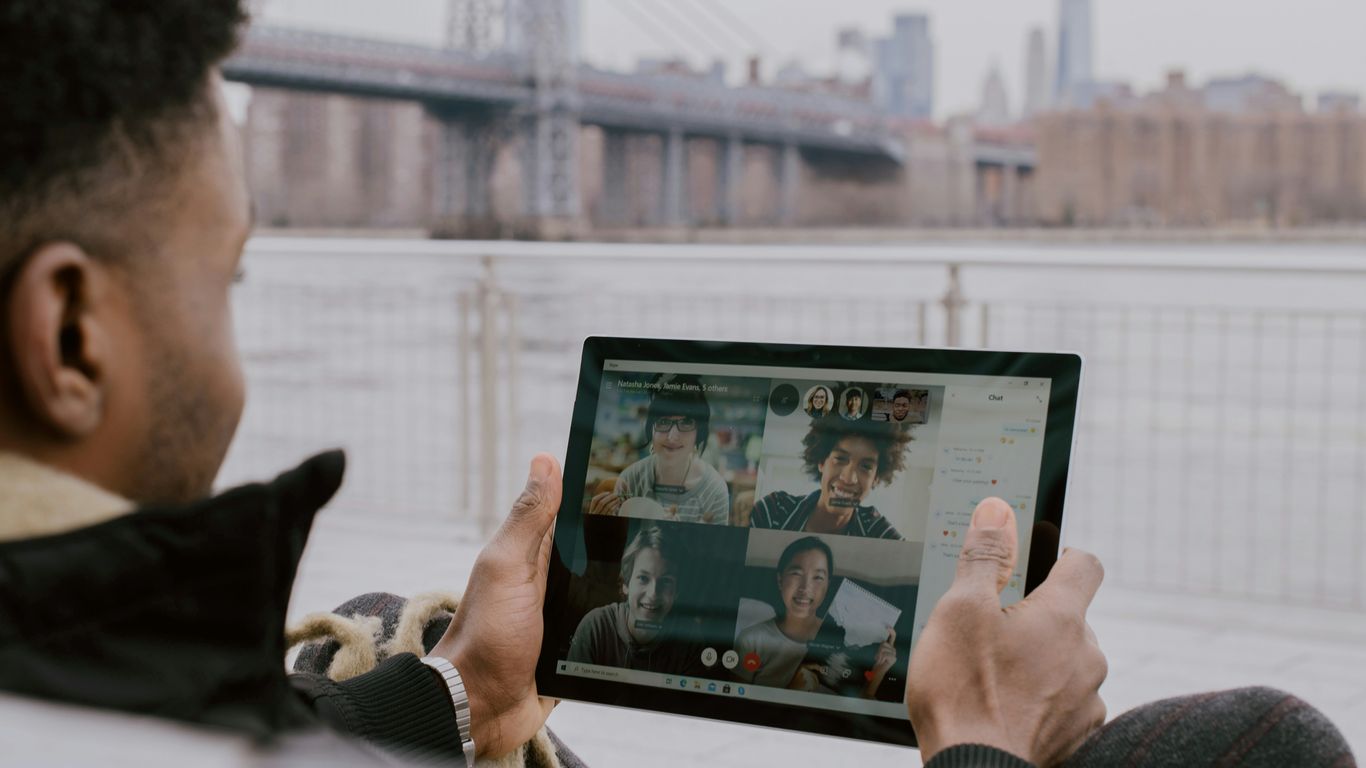 person in black long sleeve shirt holding black tablet Surface device