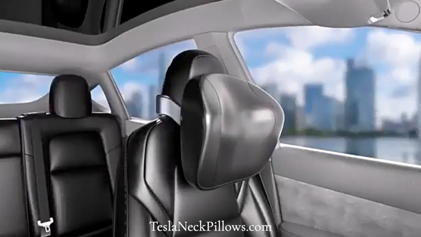 Interior of a car featuring a neck pillow on a seat.
