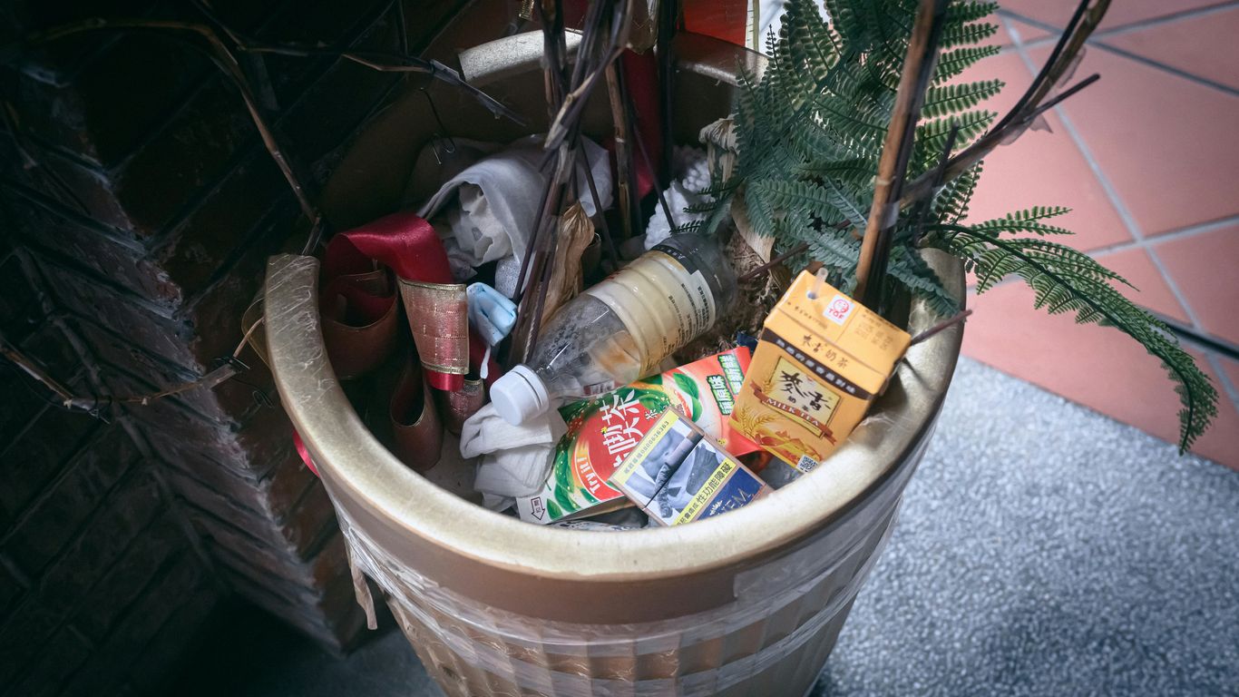 A potted plant with a bunch of garbage in it