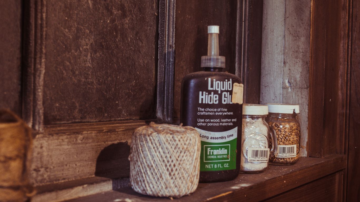 black and white plastic bottles on brown wooden shelf