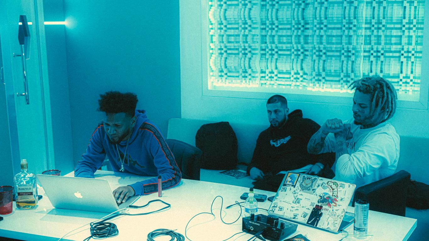 a group of people sitting around a white table