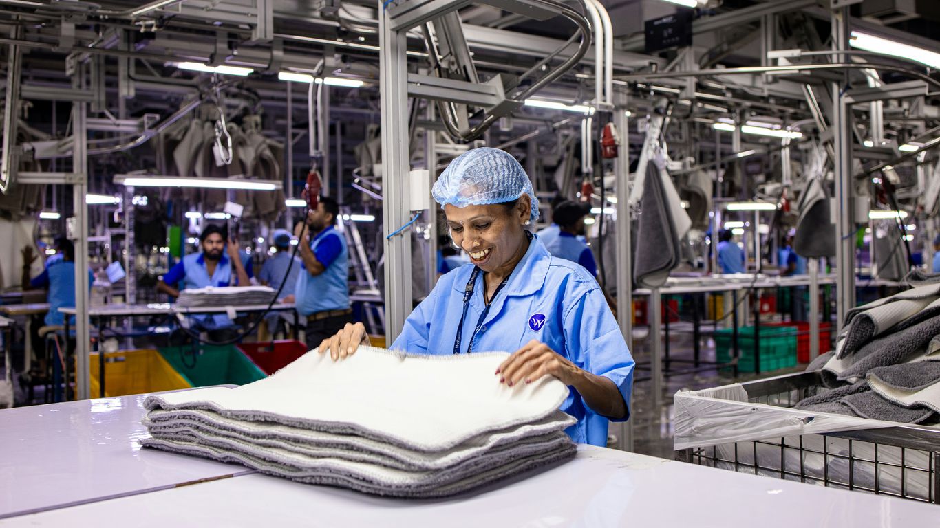 Workers are busy in an industrial clothing factory.