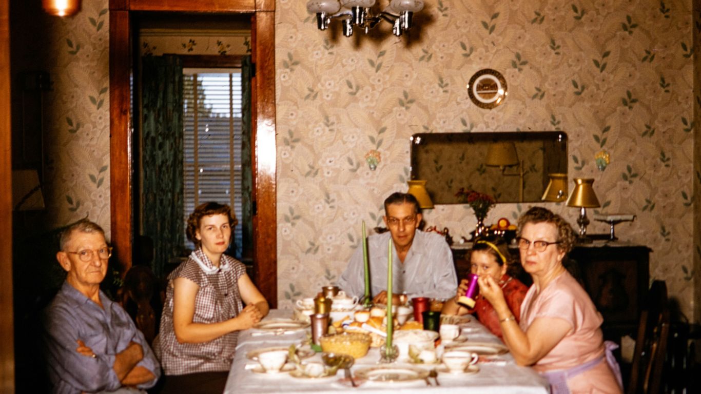 a group of people sitting around a dinner table