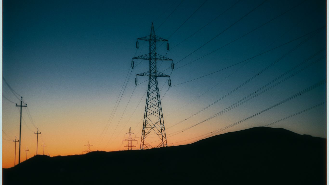 Power lines silhouetted against a twilight sky.