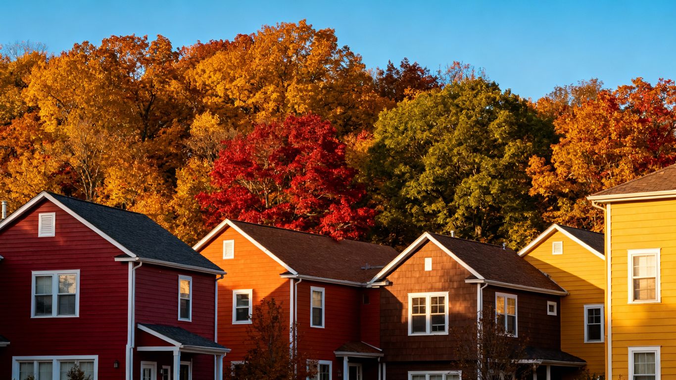 Houses with fall siding colors and autumn leaves.