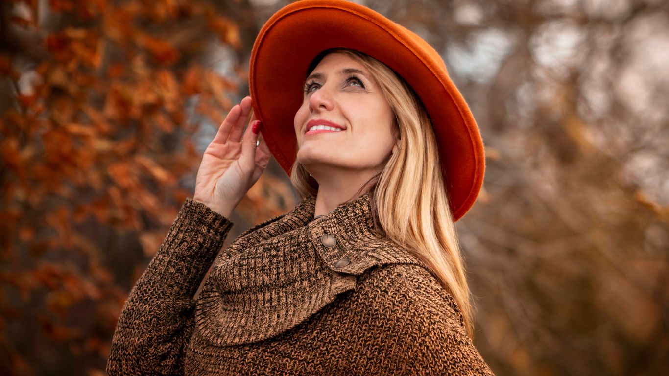 woman wearing orange hat and brown sweater