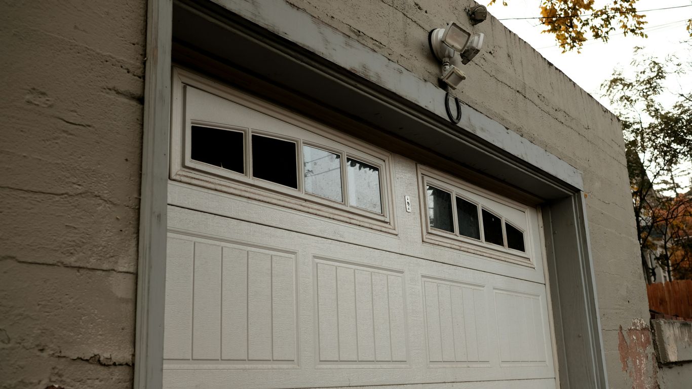 a white garage door on a brick building