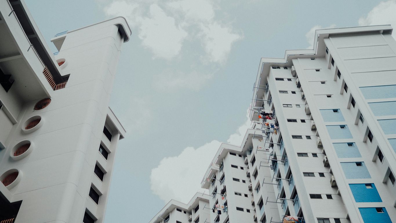 low-angle photo of white building under white sky