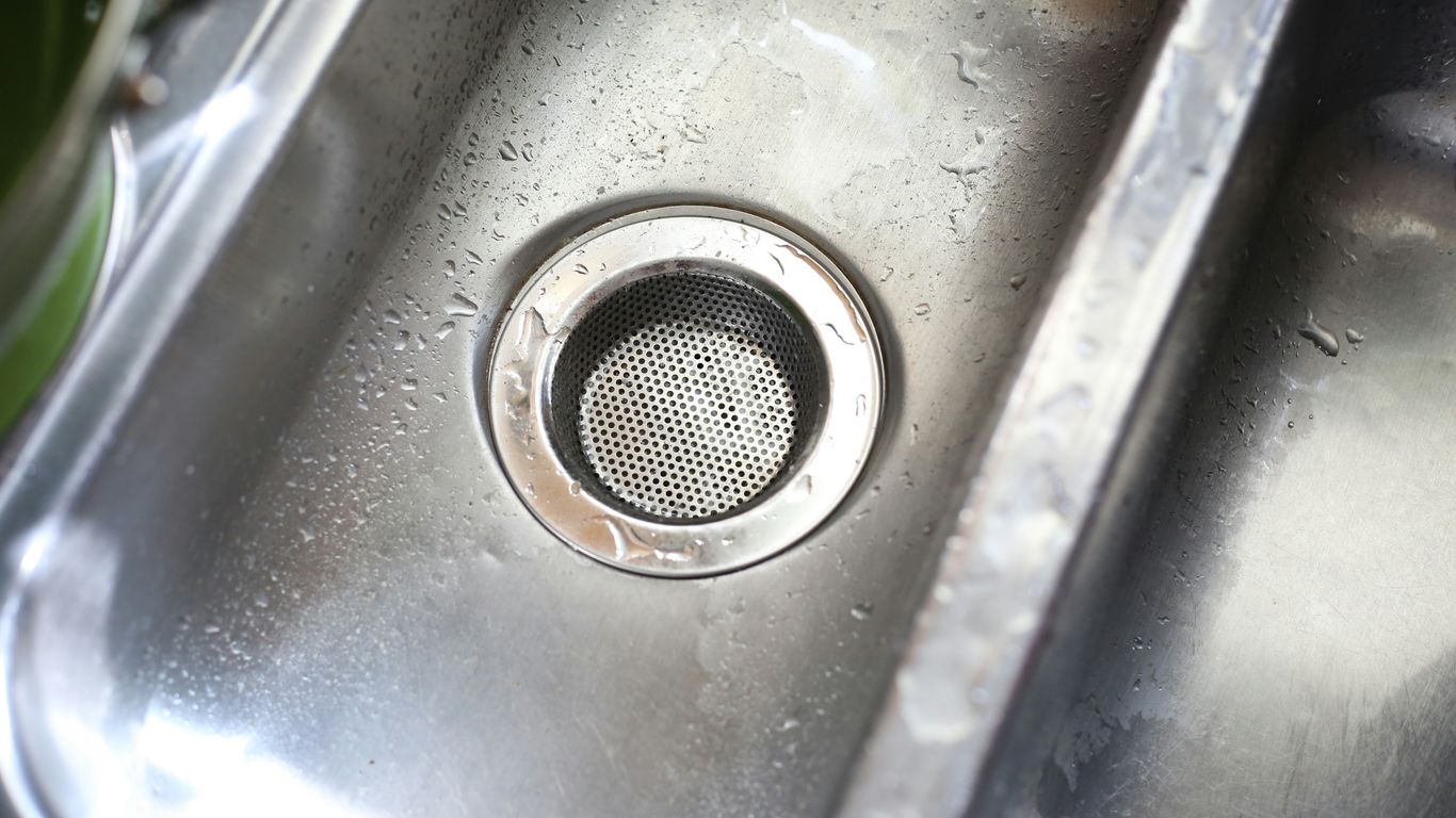 a stainless steel sink with a strainer in it