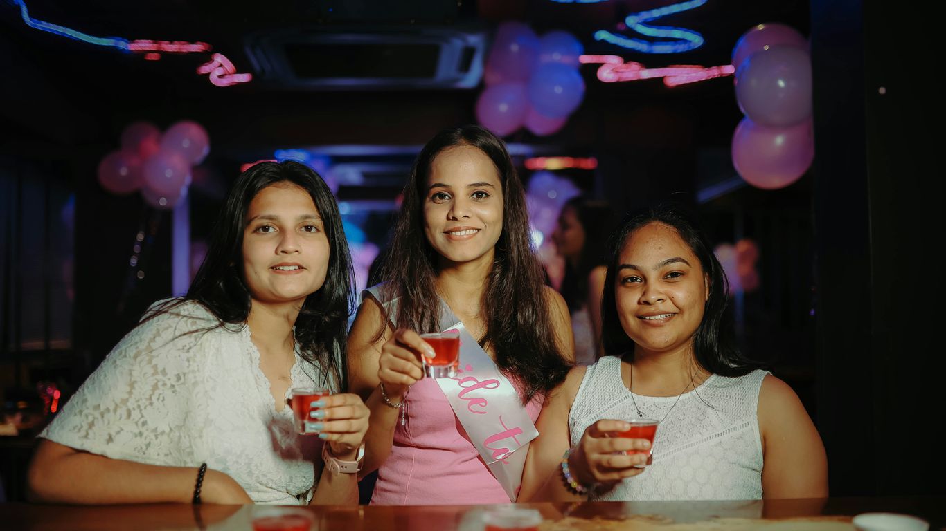 A group of women standing next to each other at a table