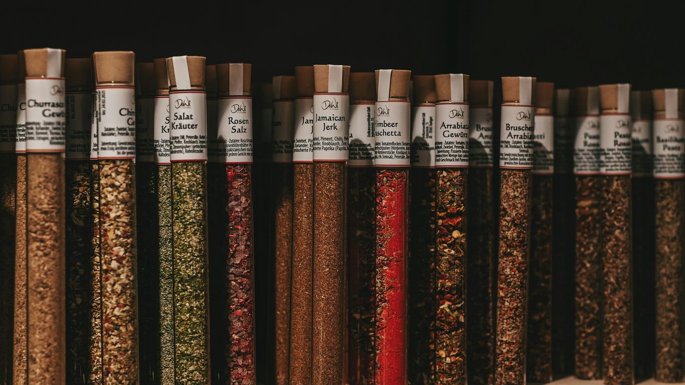 a shelf filled with lots of different types of spices
