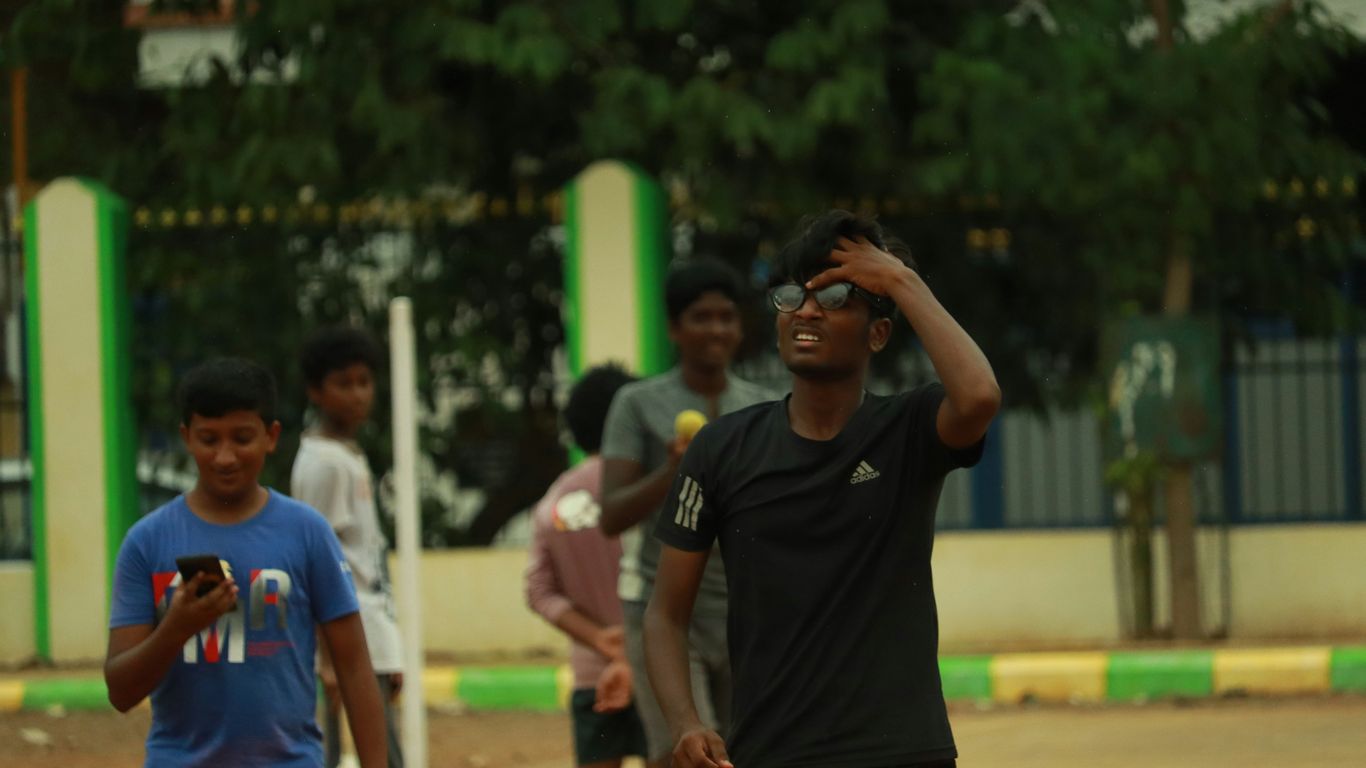 a group of young men playing a game of frisbee
