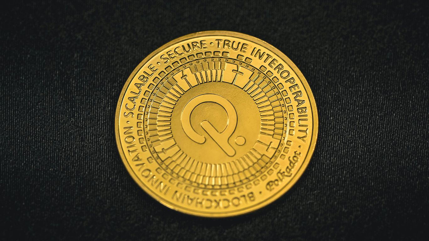 a close up of a gold coin on a black surface