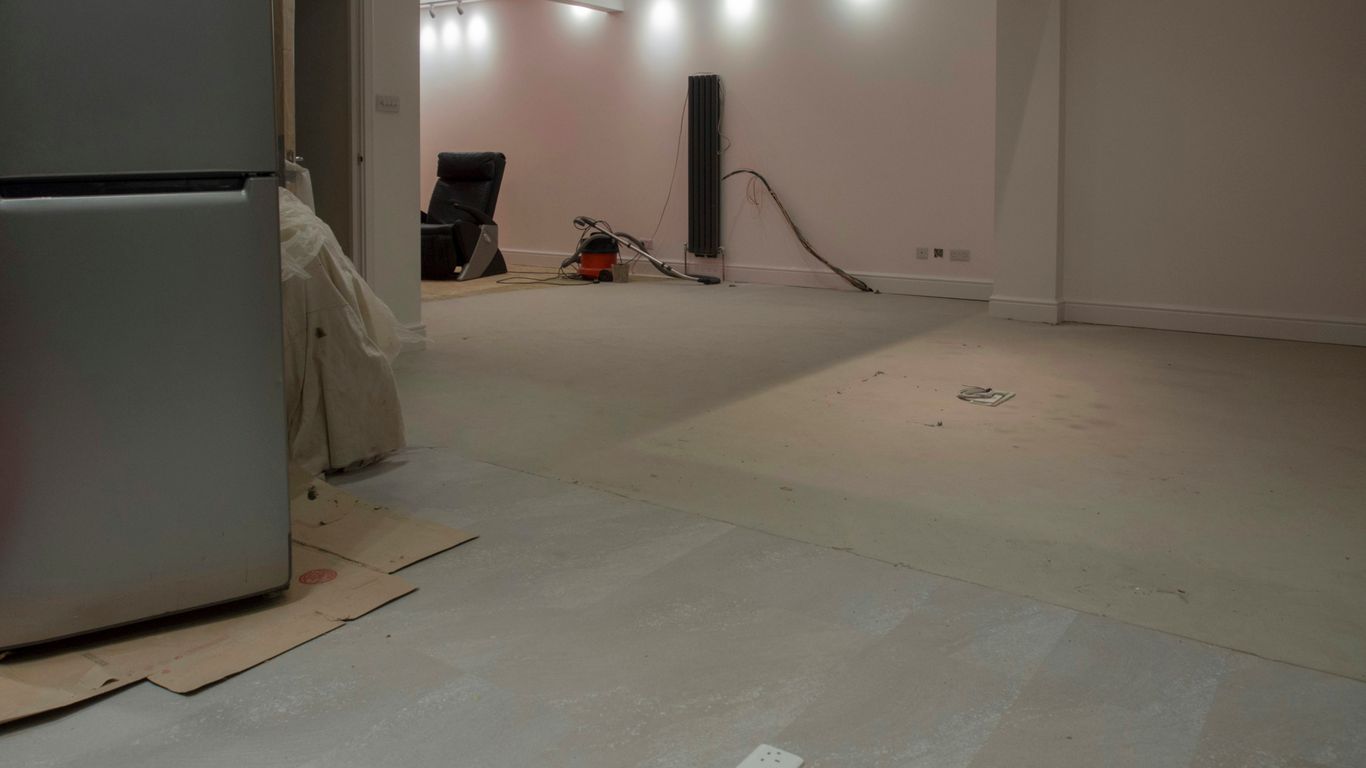 A large, empty room with some appliances.